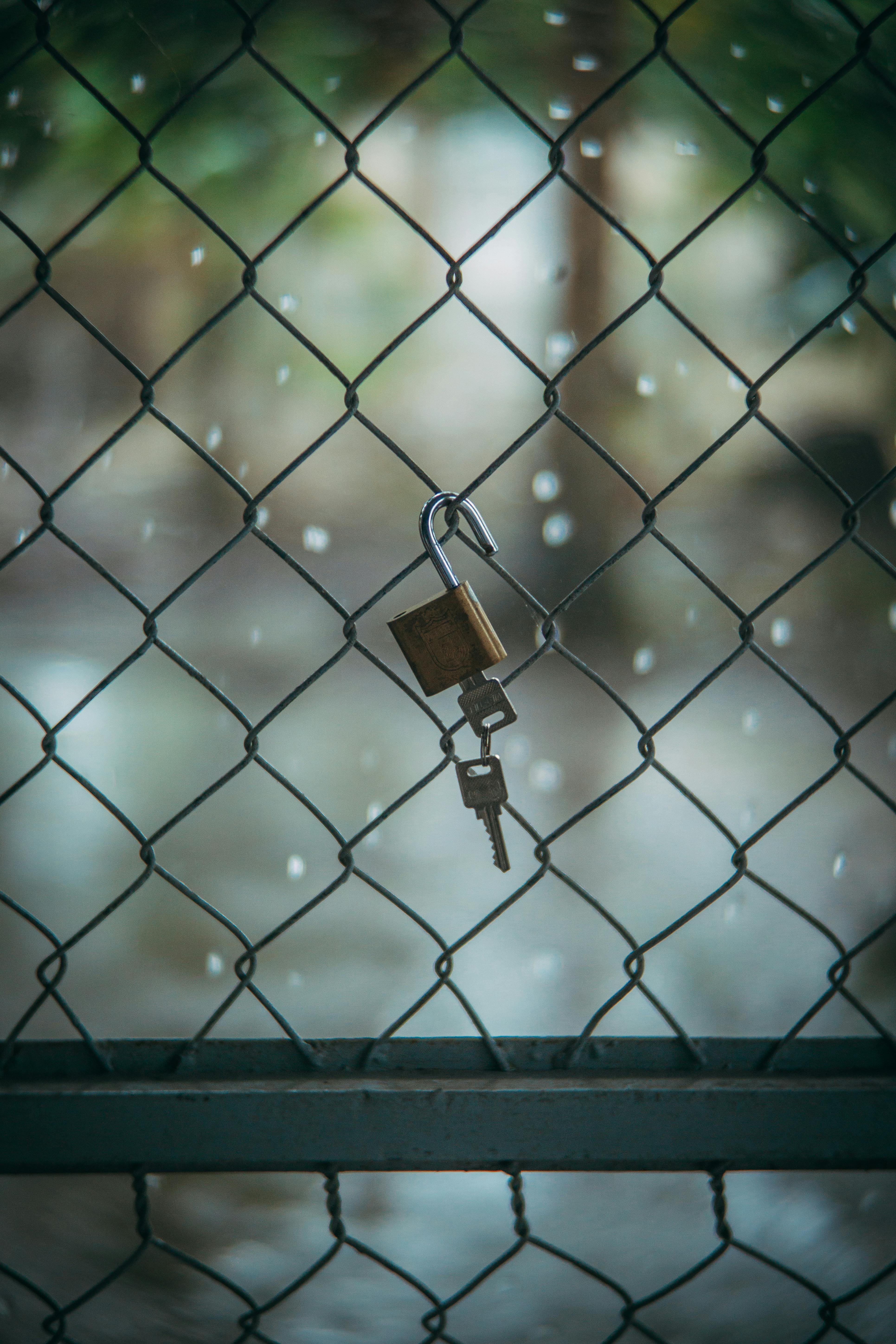 Secure padlock on chain link fence representing security services